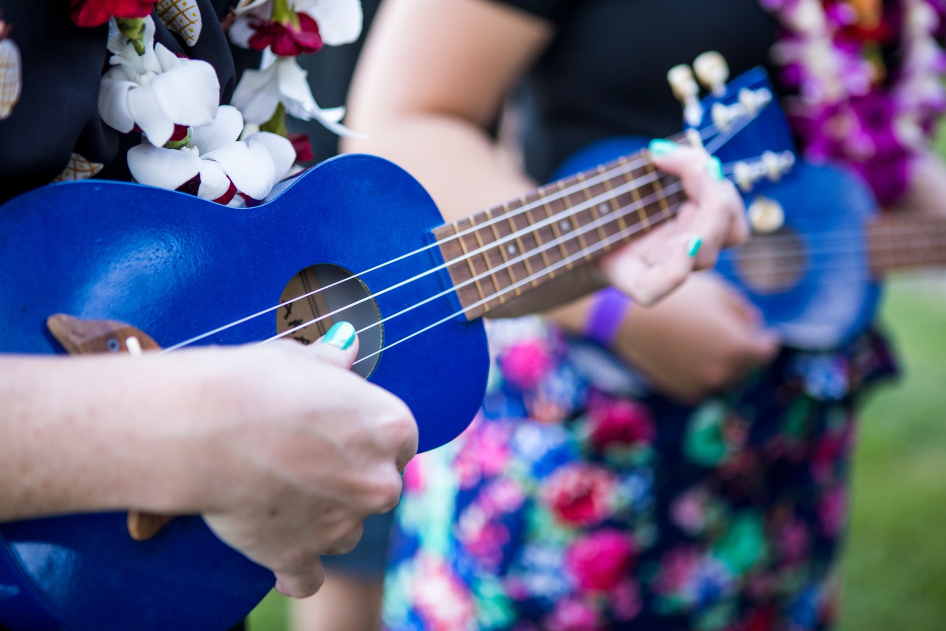 Closeup on woman playing ukulele.